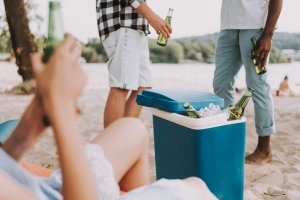 Bottles in Portable Refrigerator at Beach Party.